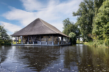 Fototapeta na wymiar Reet shed Zwartsluis at canal.. Near Giethoorn. National park de Wieden and Weerribben Netherlands. Arembergergracht. Netherlands.