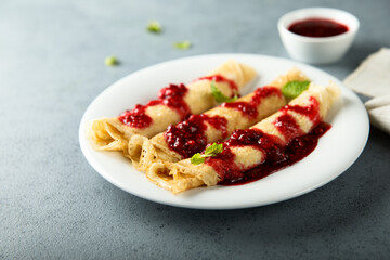Homemade crepes with raspberry sauce