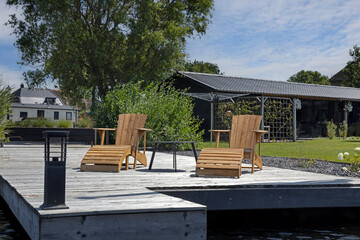 Two wooden chairs near waterside Zwartsluis. Netherlanfds