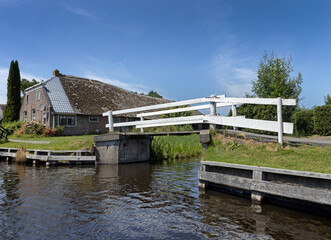Fototapeta na wymiar Bridges and houses in Belt Schutsloot. Near Giethoorn. National park de Wieden and Weerribben. Netherlands.