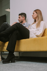 Young male and female coworkers are getting criticized by their managers for their project work....