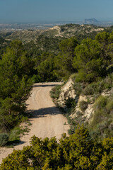 Small gravel mountain road passing over a mountain range, Costa Blanca, Alicante, Spain