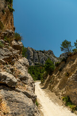 Pass del Comptador, the pass between Sella and Guadalest, small gravel mountain road used by cyclists, Costa Blanca, Alicante, Spain  - stock photo