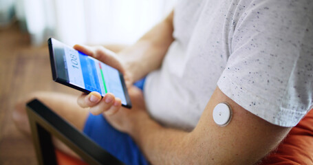 Man Using Continuous Glucose Remote Monitor Diabetes