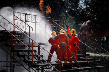 Firefighters safety using twirl water fog type fire extinguisher to fighting with fire from oil and...