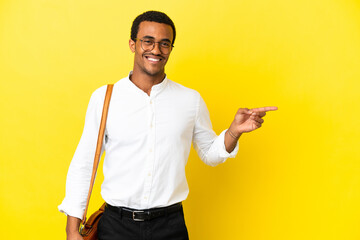 African American business man over isolated yellow background pointing finger to the side