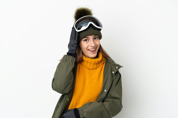 Skier caucasian woman with snowboarding glasses isolated on white background with surprise and shocked facial expression