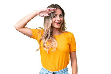 Young Uruguayan woman over isolated background saluting with hand with happy expression