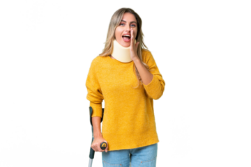 Young Uruguayan woman wearing neck brace and crutches over isolated background shouting with mouth wide open