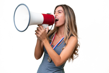 Young pretty sport Uruguayan woman with medals over isolated background shouting through a megaphone