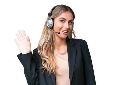 Telemarketer pretty Uruguayan woman working with a headset over isolated background saluting with hand with happy expression
