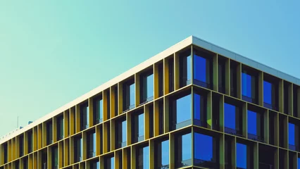 Deurstickers Berlijn Berlin Office building with a retro vibe and big blue windows. Modern minimalist building against blue sky.