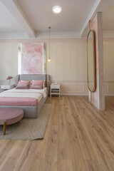 a close view of the bedroom in a modern cozy soft interior in warm delicate pastel pink and beige colors