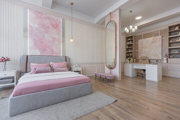 modern cozy soft interior design of a room with a bedroom and a home office in warm delicate pastel pink and beige colors