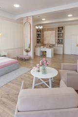 modern cozy soft interior design of a room with a bedroom and a home office in warm delicate pastel pink and beige colors