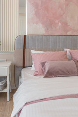 a close view of the bedroom in a modern cozy soft interior in warm delicate pastel pink and beige colors