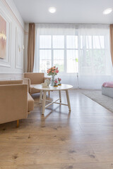 modern cozy soft interior design of a room with a bedroom and a home office in warm delicate pastel pink and beige colors