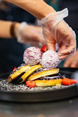 woman chef hand cooking pancakes with blueberry jam and ice cream on kitchen