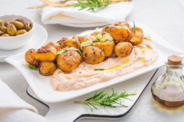Whipped feta, ricotta, cheese dip (Tirokafteri) with crispy baked potatoes and grilled olives