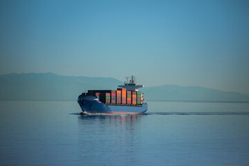 Cargo/ commercial ship traveling in the Aegean Sea in Greece, carrying containers.
