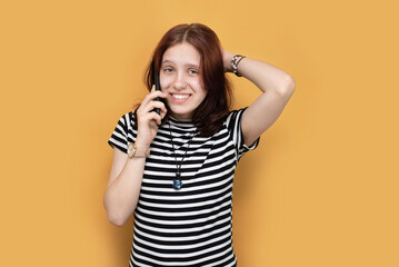 A teenage girl is talking on the phone with sarcasm on face, she listens to what her mother says...