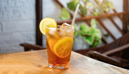Refreshing with glass of Iced Tea add Lemon juice on wooden table mai tai