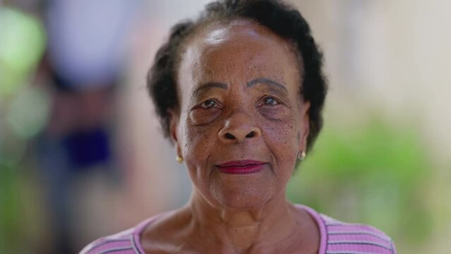 Close-up face of a black Brazilian senior woman with neutral expression. African American elderly person portrait