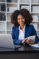 Business woman working on laptop and accounting financial report, accountant using calculator to calculate tax refund at office.