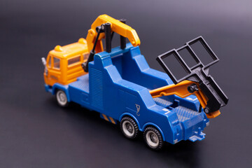 Toy tow truck on black background