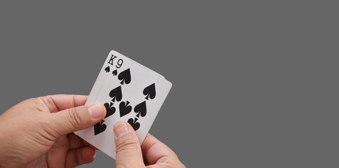 Hand holding poker card playing isolated on white background with clipping paths.