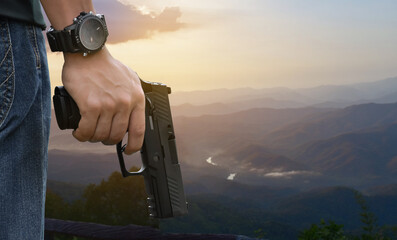9mm pistol gun holding in hand of gunshooter, soft and selective focus.