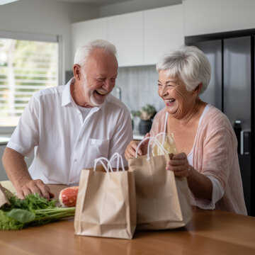 Smiling grandparents holding grocery shopping bag at home