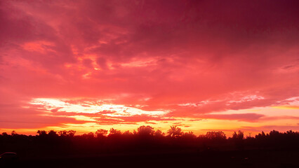 Amazing Sunset and sunrise.Beautiful african red and orange sunset with silhouettes of acacia trees and sun setting on the horizon.