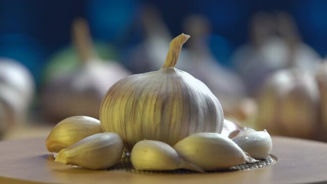 fresh garlic swirling on a wooden table