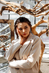 Portrait of a girl in a jacket with wet hair and makeup