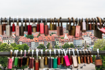 Beautiful row of houses at the Domplatz in Erfurt, seen through two poles with love locks