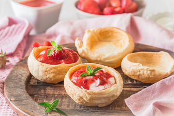Homemade croissant buns filled with cream and strawberry puree