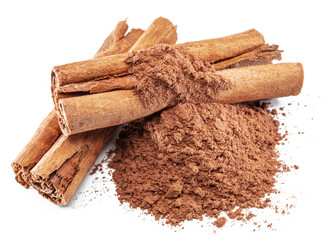 Cinnamon spice -dried bark strips and ground cinnamon isolated on white background.