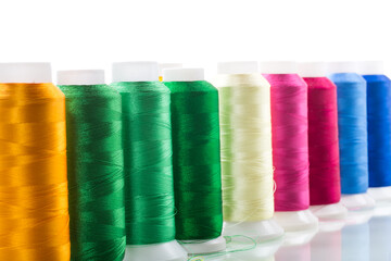 set of different color sewing threads,on white background.