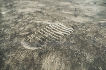 Large footprint on the sand. Footprint on the moon background