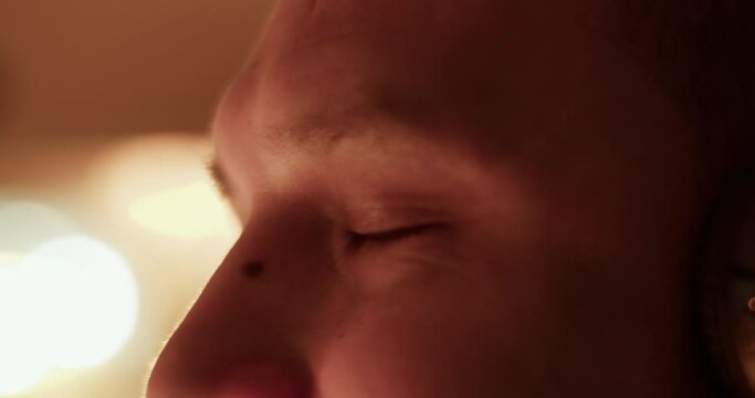 Crop man nodding head while listening to music