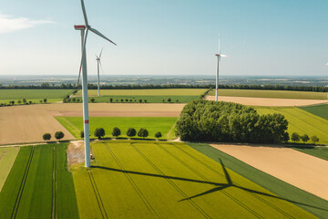 landscape with wind turbines in agricultural fields - obrazy, fototapety, plakaty