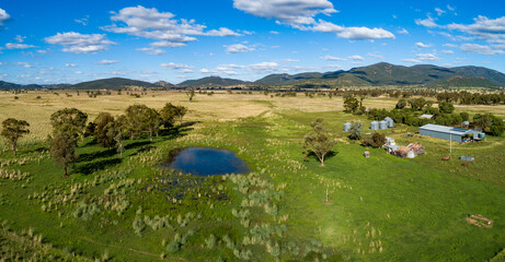 Dam in green farm paddock on sunlit day in NSW Australia