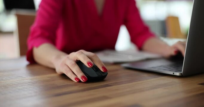 Woman use computer mouse working on computer at table closeup. Remote work freelance and IT career