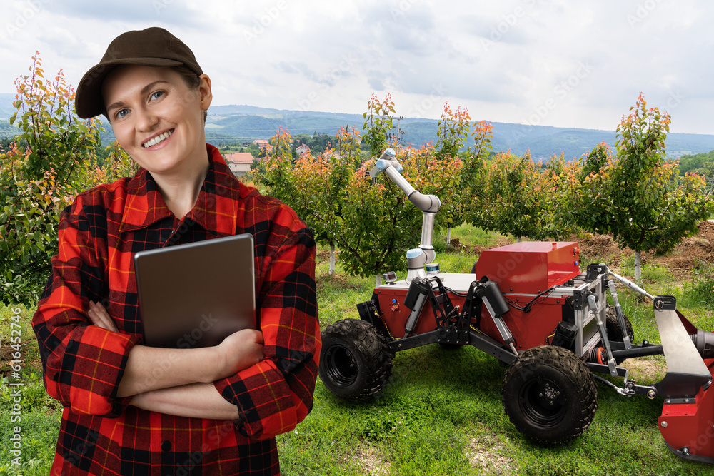 Aufkleber farmer controls autonomous robot in a fruit garden. smart farming concept.