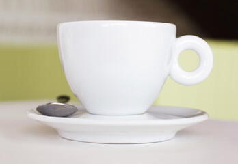 Closeup, white cup and saucer in cafe, coffee shop and order for hot drinks beverage. Background, table crockery and teacup for drinking latte, cappuccino and espresso in restaurant or food industry