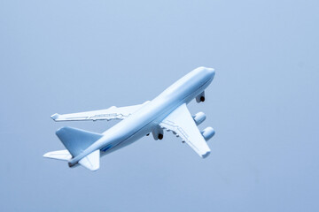 Airplane in the blue sky, closeup of photo with soft focus