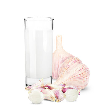 milk in a glass and garlic isolated on a white background