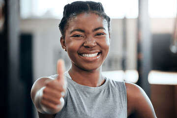 Fitness, portrait or happy black woman with thumbs up in gym training with positive mindset or motivation. Wellness, smile or healthy personal trainer in workout with a like hand gesture for support