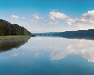 Fototapeta premium Autumn misty evening lake with grove on shore